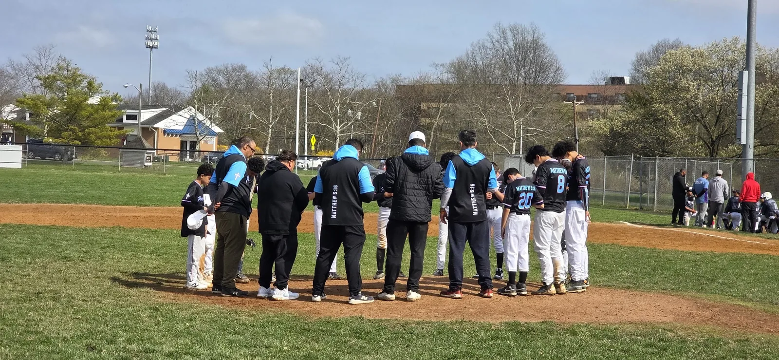 Team in prayer huddle on the field